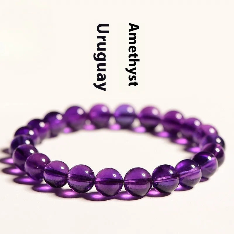 Adjustable bracelet with scattered, polished natural amethyst beads from Uruguay on a wrist.