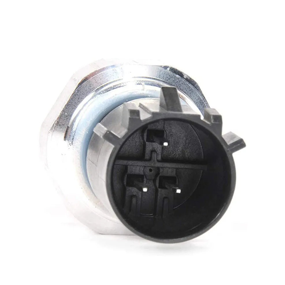 Silver automobile fuel pressure sensor on a white background.