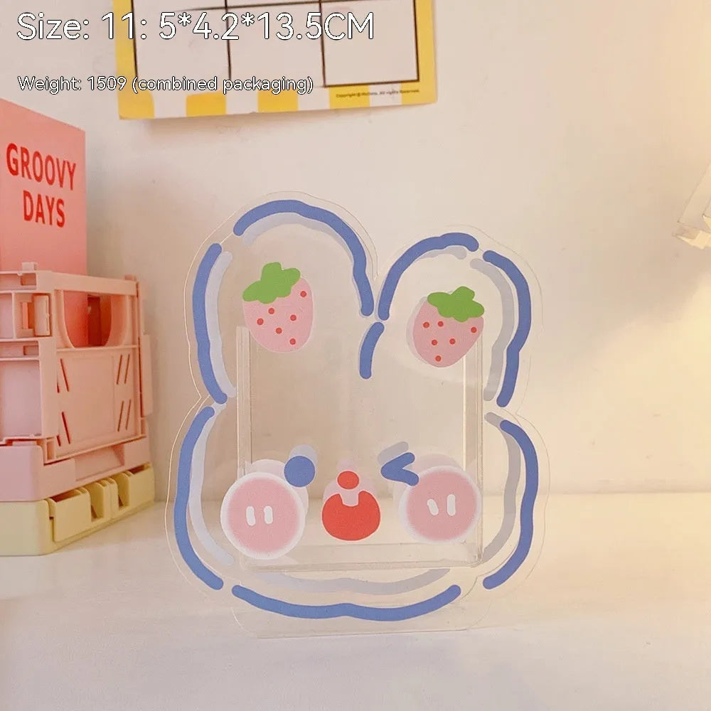 Clear square acrylic storage box with a cute cartoon rabbit design, sitting on a wooden desk.