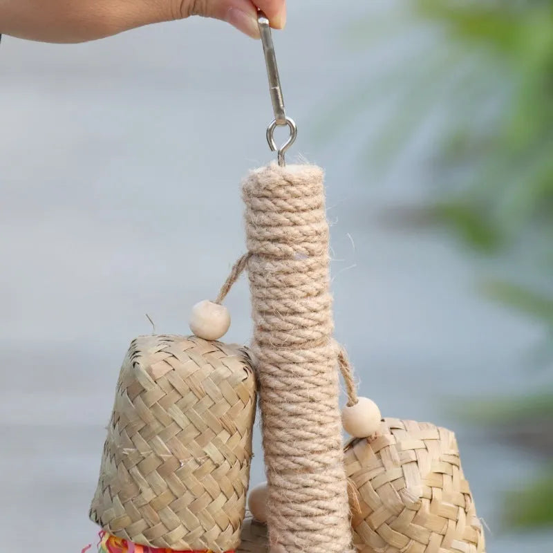 Wooden parrot chewing toy with colourful shredded paper decorations and sisal rope attachments