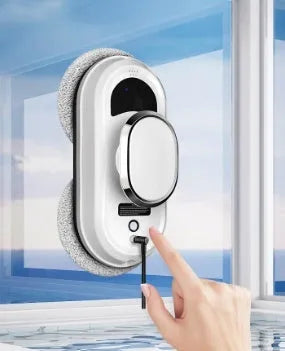 White full-automatic high-altitude window cleaning robot with remote control on a table.