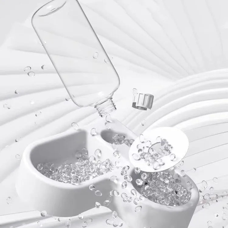 White food-grade silicone pet water fountain with pump and filter on a kitchen floor.