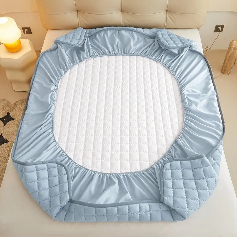 Washed cotton waterproof fitted sheet for beds in blue, shown on a mattress