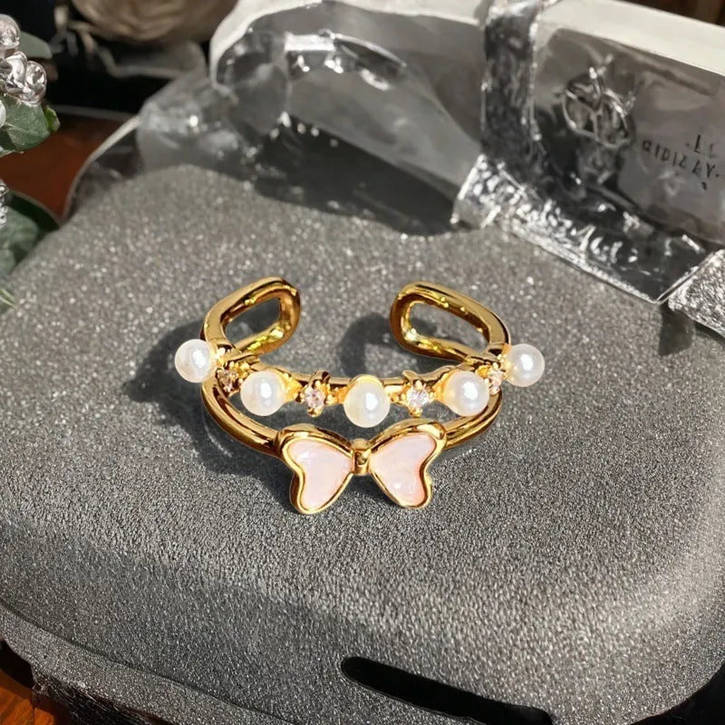 Close-up of an adjustable copper ring with a vintage oil-drip finish and a central gourd motif set with zircon stones.