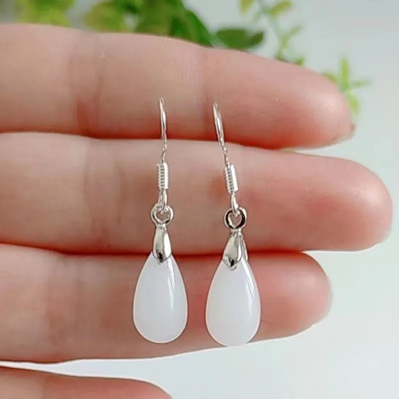Natural Hetian water drop jade earrings on display showing gray jade colour with alloy ear wire
