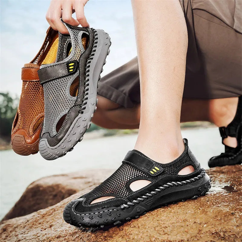 Men's black casual sandals with mesh upper and Velcro strap on a rubber sole.