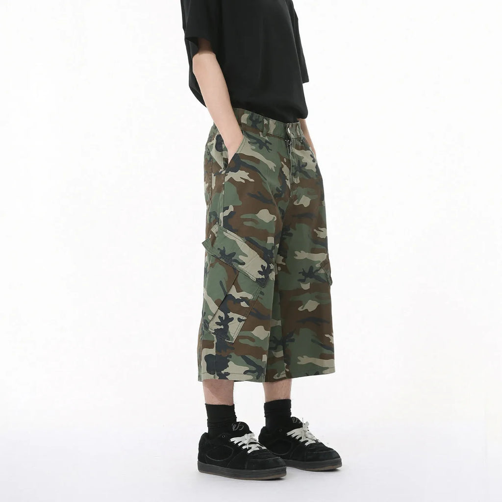 Man wearing loose camouflage print cotton jeans with wide legs and side stitching.