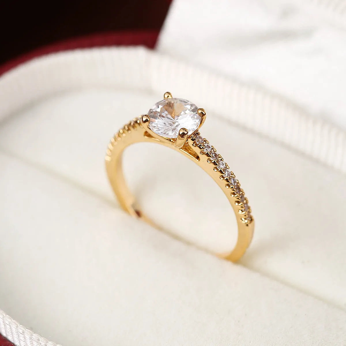 Copper zircon hexagonal geometric ring in a gold rose red electroplated finish.
