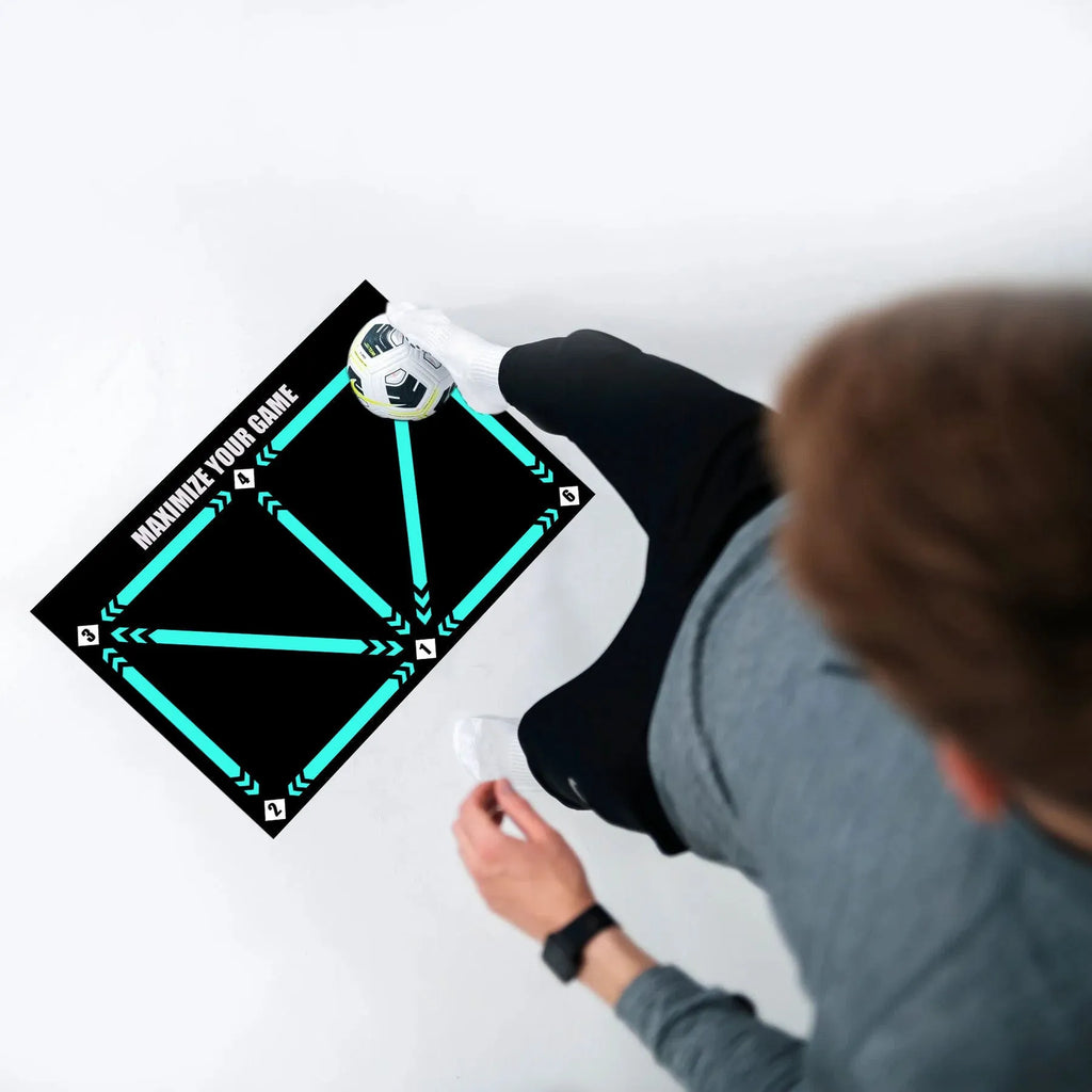 Black rectangular non-slip football training mat measuring 60 by 90 centimetres.