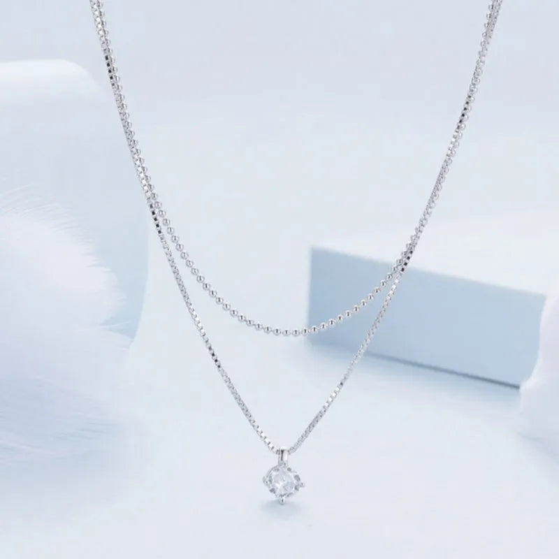 Double-layer sterling silver necklace with pearl chain and adjustable clasp