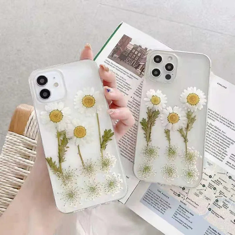 White epoxy daisy floral design on a clear TPU protective case for iPhone models.