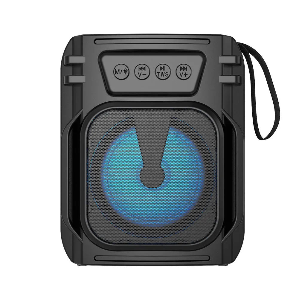 Compact portable Bluetooth speaker with USB charging cable on a table.