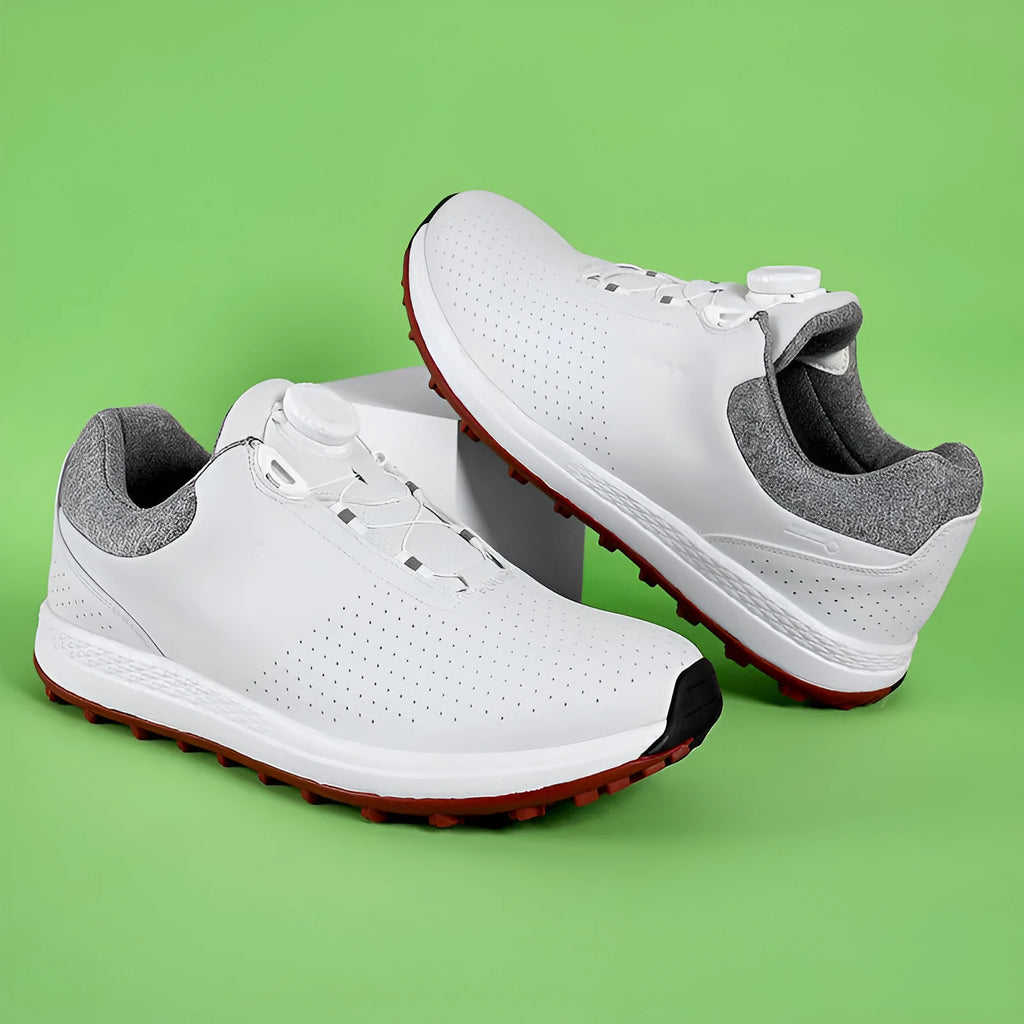 Men's low-top white casual golf sneakers with breathable upper and non-slip rubber sole on grass