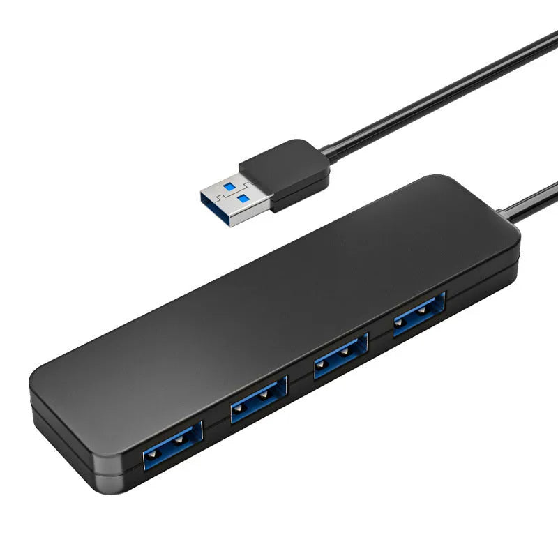 Black USB 3.0 hub with four ports, LED indicators, and a 30 cm attached cable on a desk.