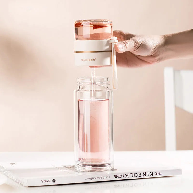 Glass water bottle with tea infuser filter showing double wall construction and portable rope