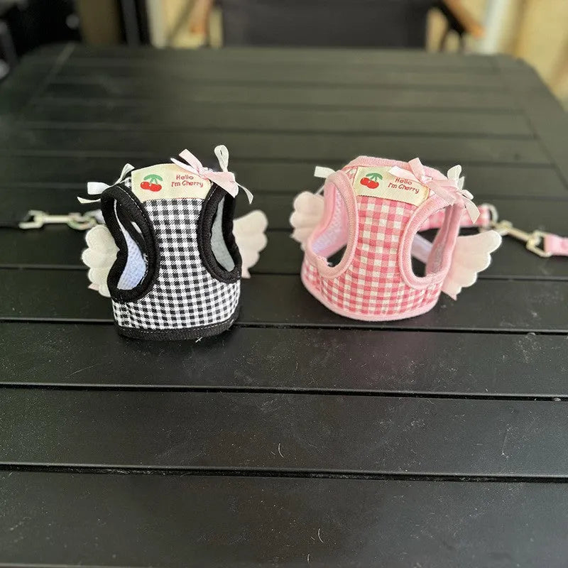 Pink cotton chest and back hand holding rope harness for a small dog on a white background.