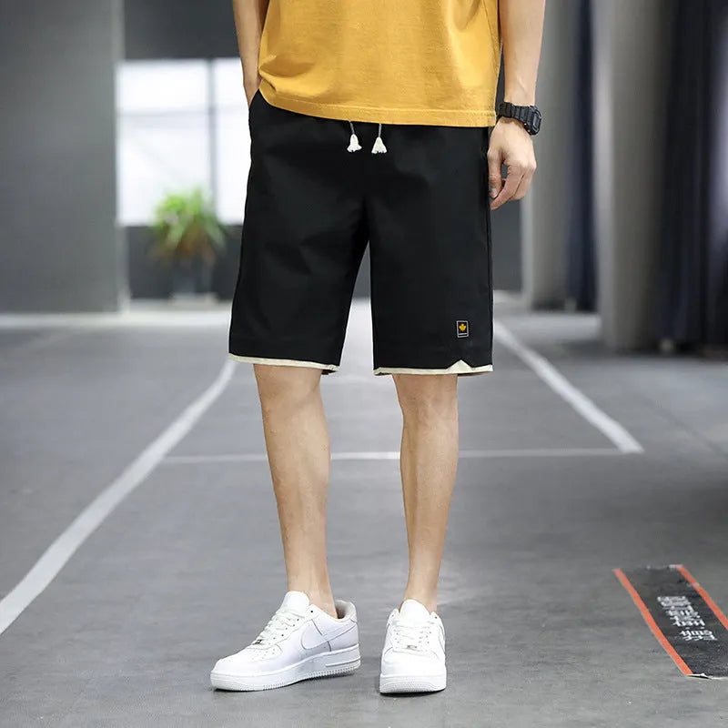 Casual loose straight-leg beach shorts on a plain background, shown in a green colour variant.