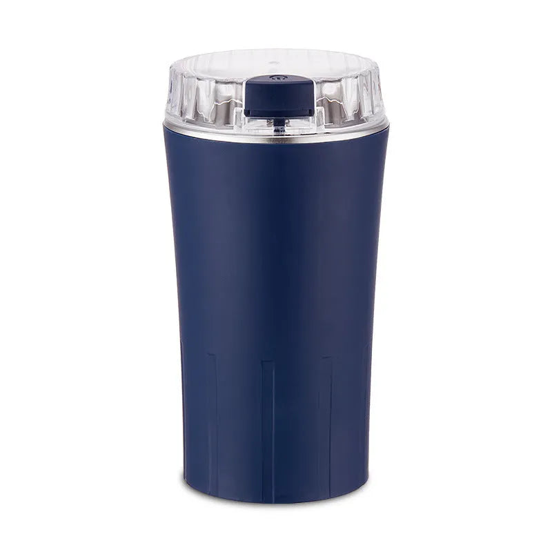 Blue mini flour mill and grinder with stainless steel construction on a kitchen counter.