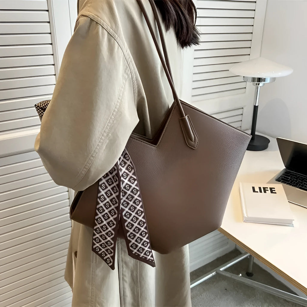 Beige women's large shoulder bag made of PU leather with multiple pockets and an adjustable strap.