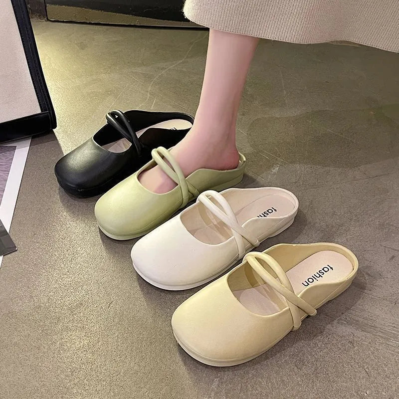 Women's black closed-toe plastic flip flops on a plain background, showing baotou style and strap design.
