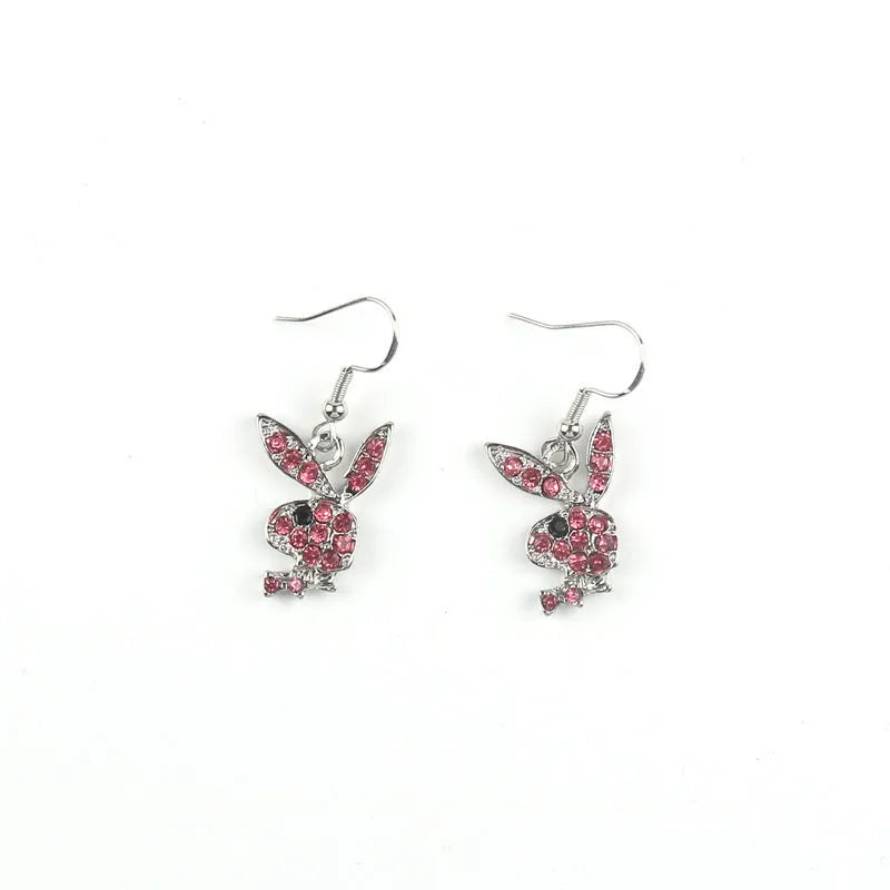Close-up of a pair of sparkling rabbit silhouette stud earrings with cubic zirconia stones on a silver background.