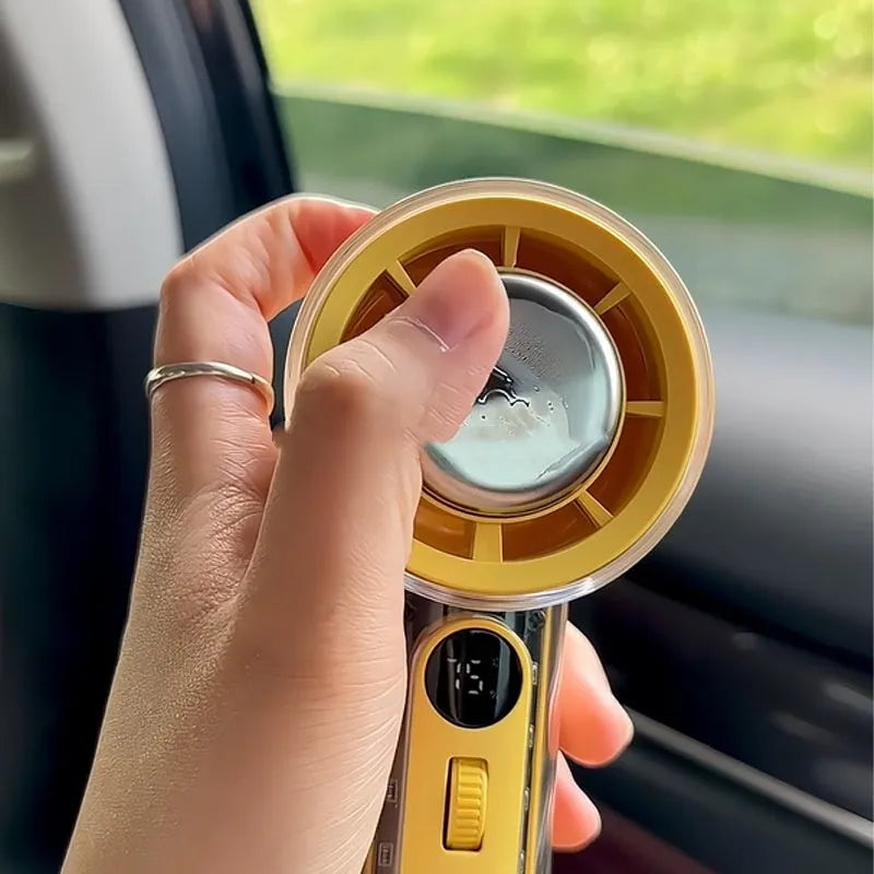 Yellow handheld fan with ice compress function showing compact size and USB port.