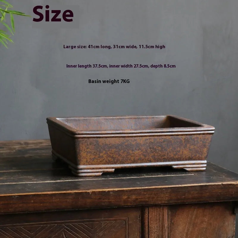 Rectangular purple sand bonsai pot with five-line textured pattern, shown empty on a wooden surface.