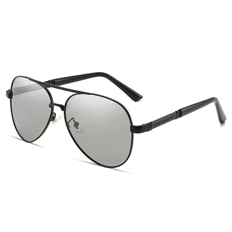 Man wearing gold metal frame polarised sunglasses with dragon decoration and grey lenses.