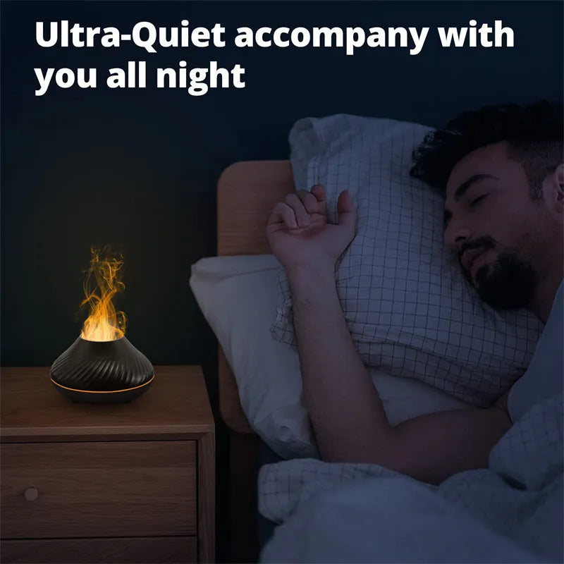 Beige volcanic flame aroma diffuser with LED light on a wooden table next to an essential oil bottle