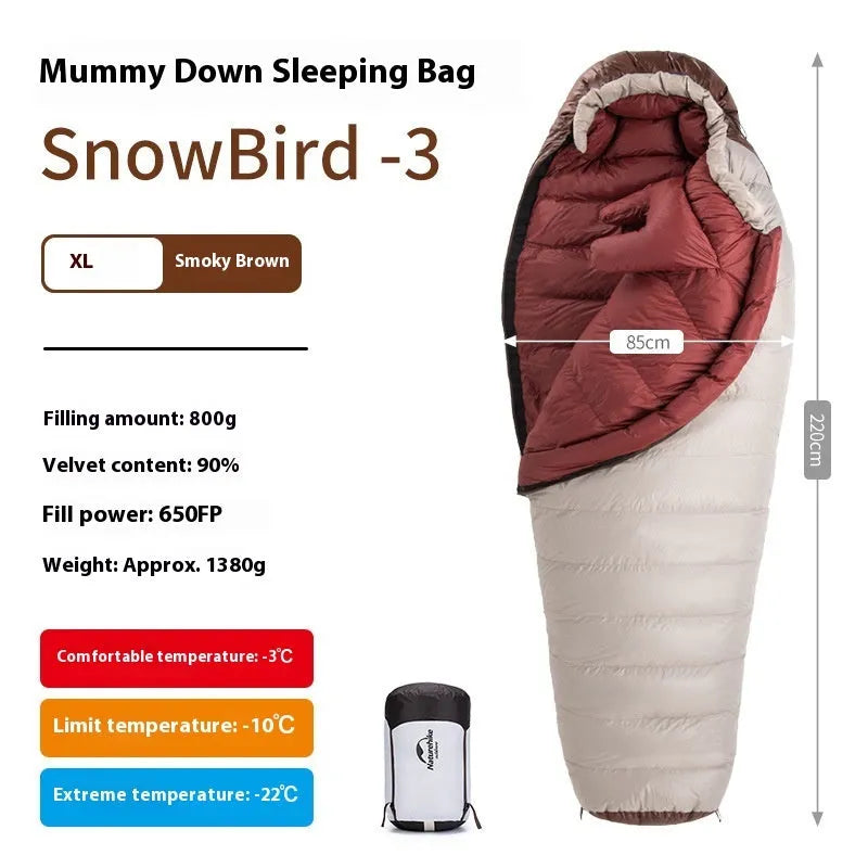 Goose down mummy sleeping bag in a stuff sack, part of the snowbird range for camping.