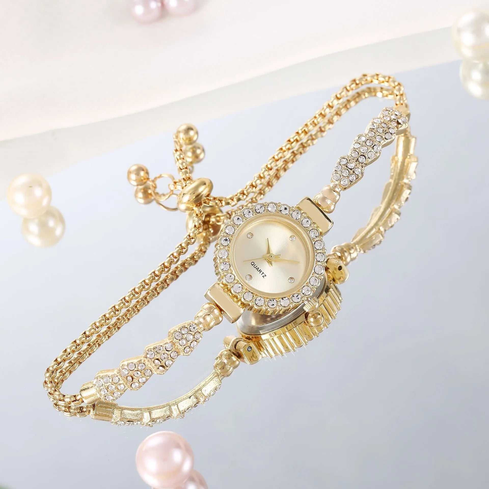 Gold fine strap women's watch with round dial and stainless steel jewellery buckle