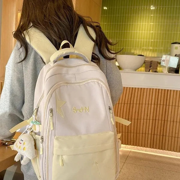 Mori style nylon backpack for women, light blue colour, shown with pendant on a plain background