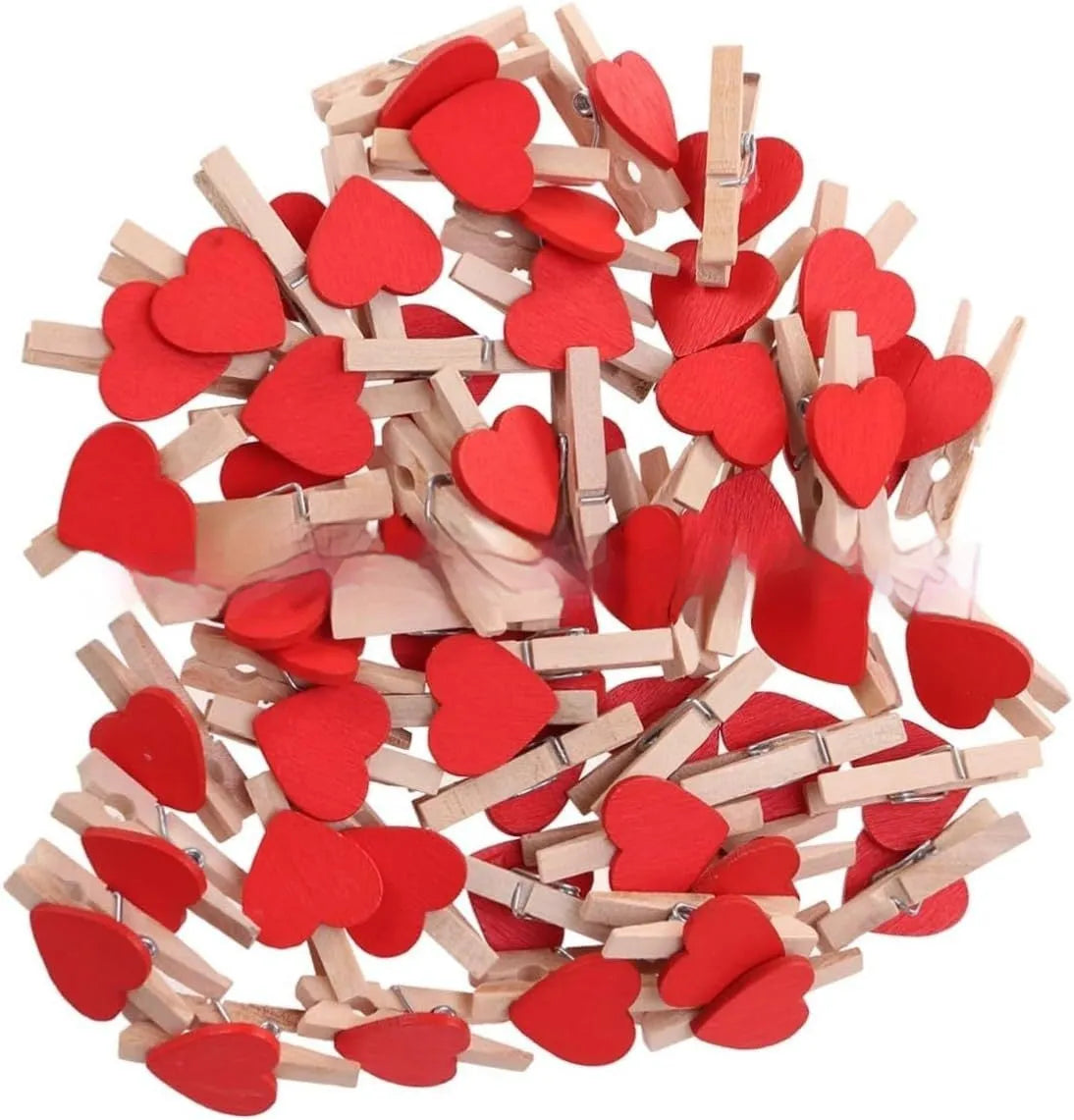 Five small wooden heart-shaped clips in red, pink, white, yellow, and rose colours on a wooden surface.