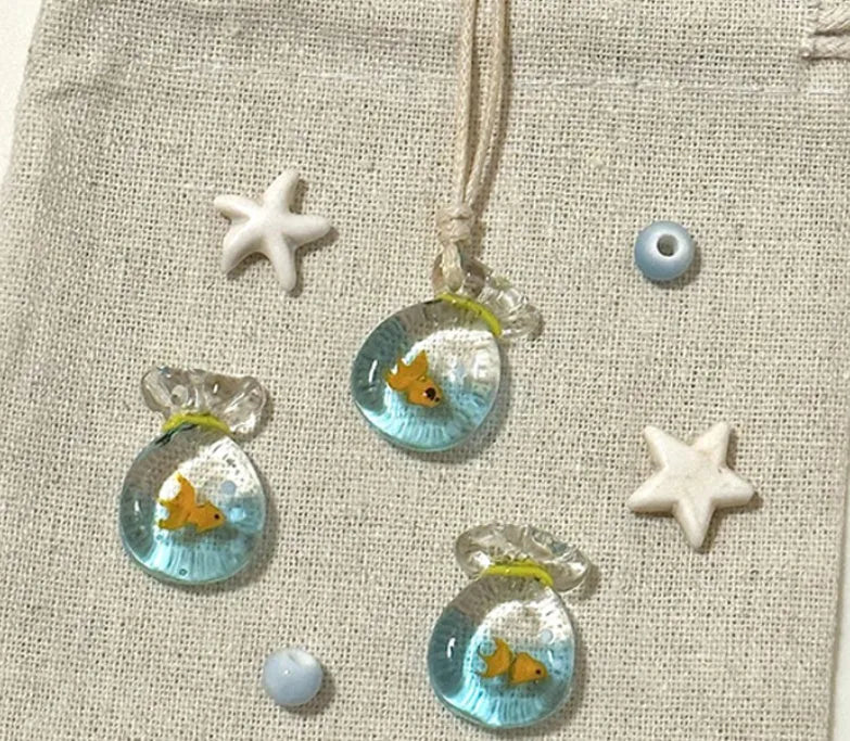 Women's coloured glaze pendant necklace on a beige cotton-linen cord, showing Skirt and Joker design details.