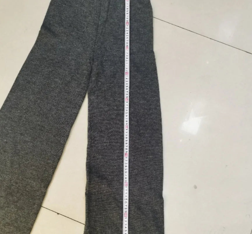 Women's dark grey side-slit knit top and matching trousers, a two-piece acrylic suit set laid flat.