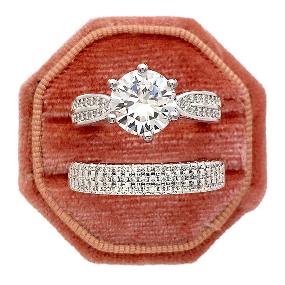 A white gold-coloured geometric bracelet ring with an integrated round element on a model's finger.