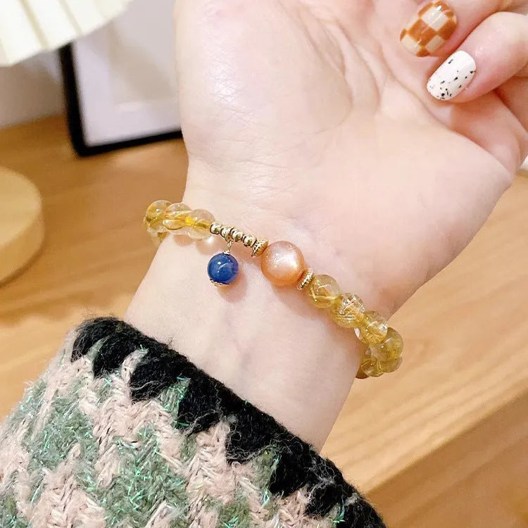 Handmade natural gold rutilated quartz and sunstone crystal bracelet with round diamond-shaped elements