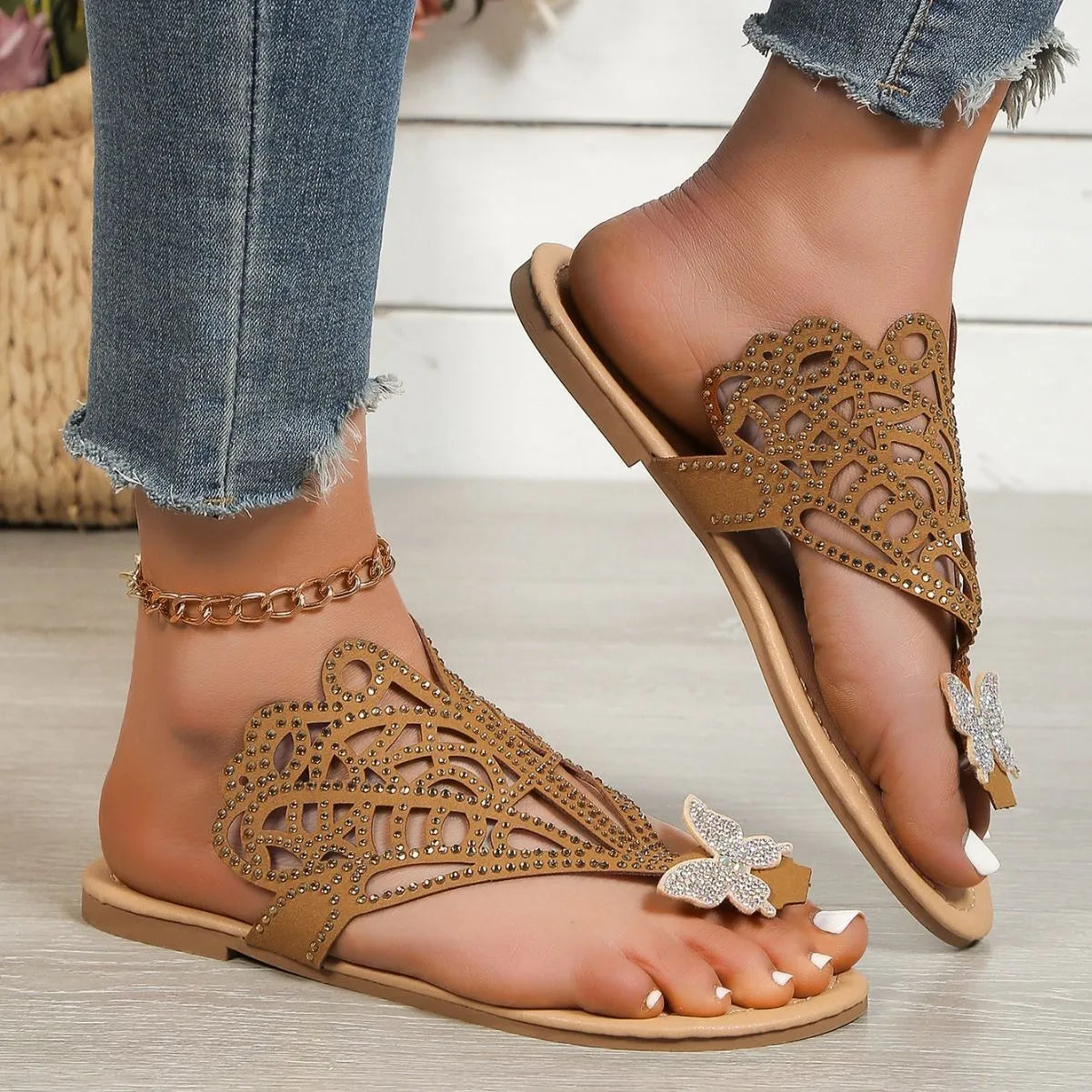 Women's black slip-on sandals with rhinestone decoration on a flip-toe, hollowed slipper design.