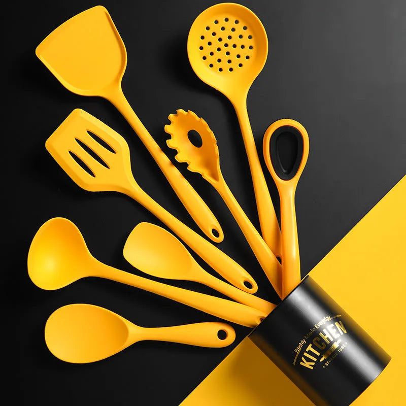 Yellow silicone nylon nonstick cooking spoon spatula kitchen utensils set on surface