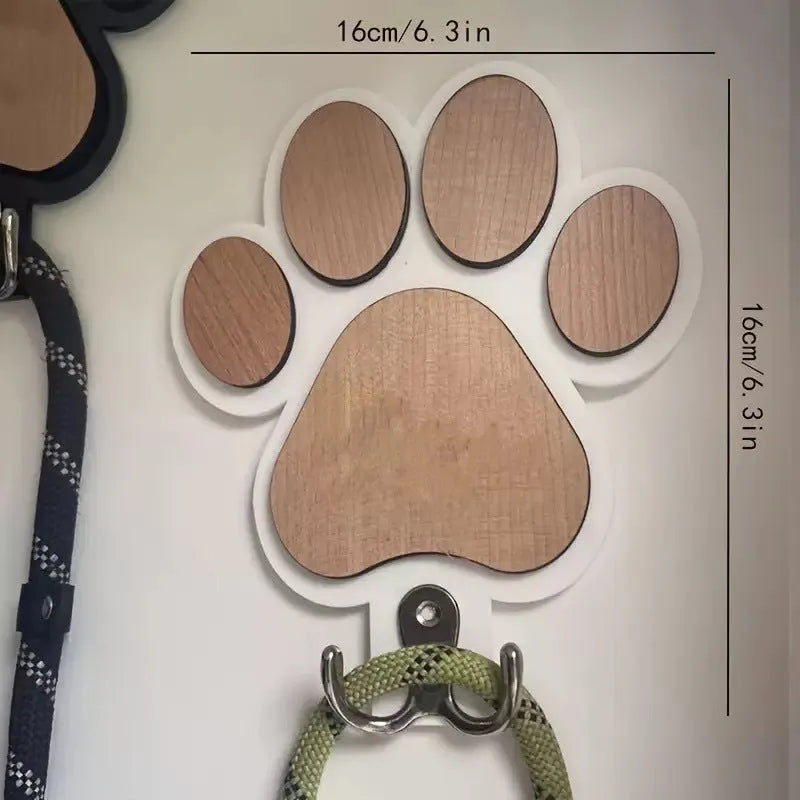 Wooden foot paw print wall hook in black on a white background, showing its shape and design.