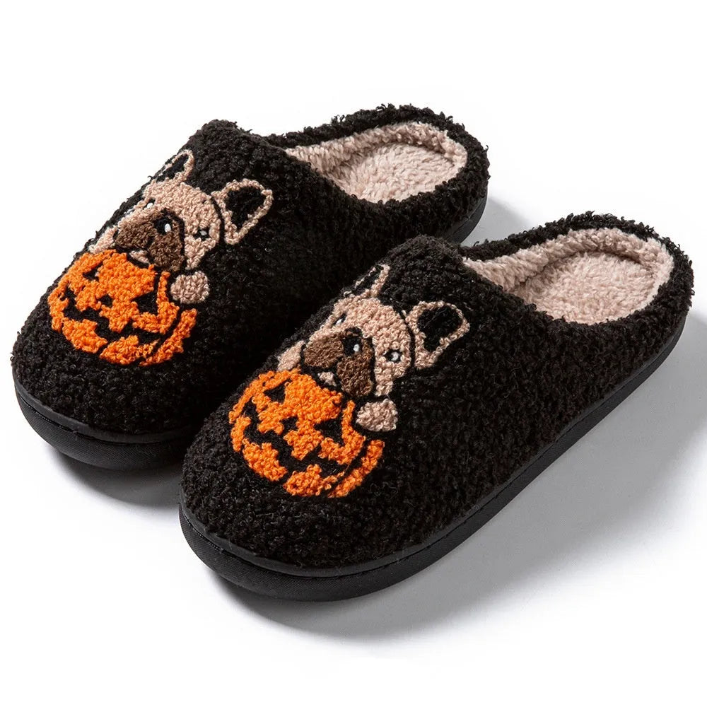 Black and white Halloween plush slippers with pumpkin pattern and non-slip rubber soles.