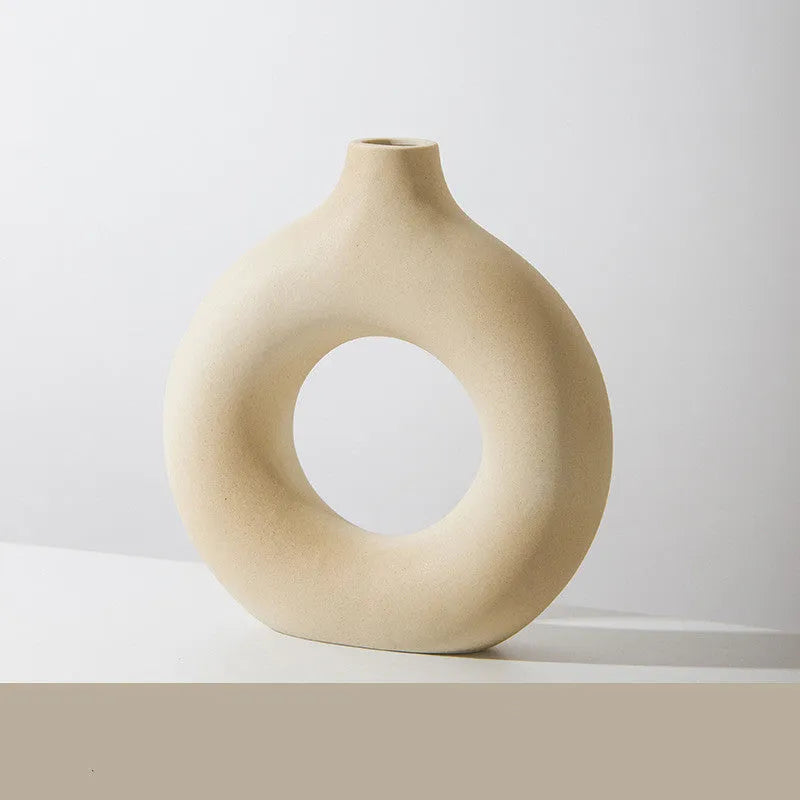 Frosted unglazed porcelain biscuit vase in a simple modern style on a table.