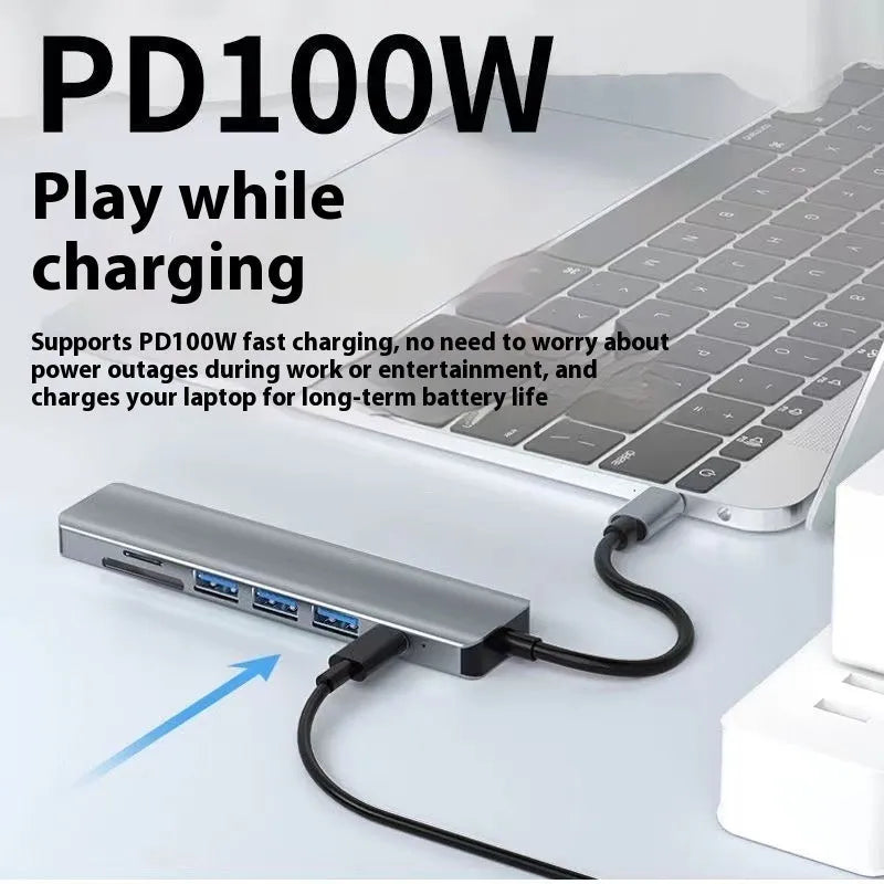 Silver aluminium USB-C 7-in-1 expansion dock with HDMI, USB ports, SD slots, and a 15cm cable.