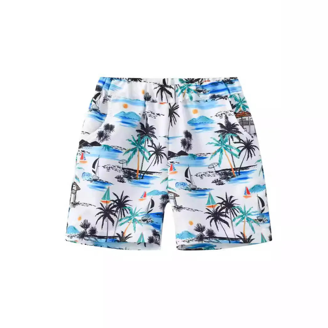 Children's elastic waist beach shorts with colourful coconut tree print, shown in shorts length.