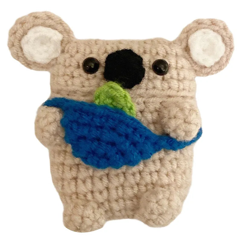Handmade knitted koala bear backpack-shaped cover for an AirPods charging case.