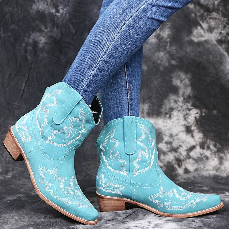 Women's blue embroidered cowboy boots with low wedge heel and pointed toe.