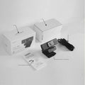 Black ABS plastic USB computer webcam with a detached magnetic privacy cover on a desk.