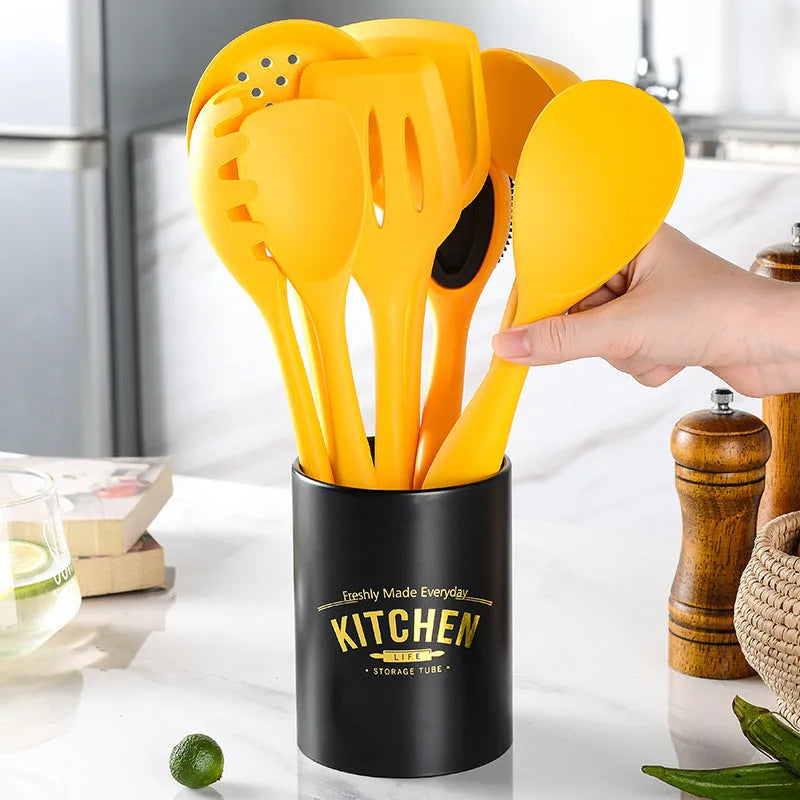 Yellow silicone nylon nonstick cooking spoon spatula kitchen utensils set on surface
