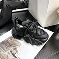 Women's creamy white casual wedge sneakers with lace-up front and cross-strap detail.