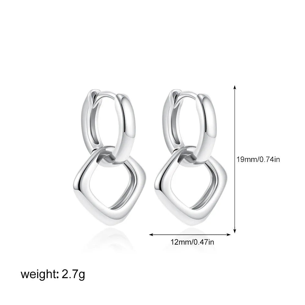Double ring twist geometric square ear clip simple copper earrings on a neutral background